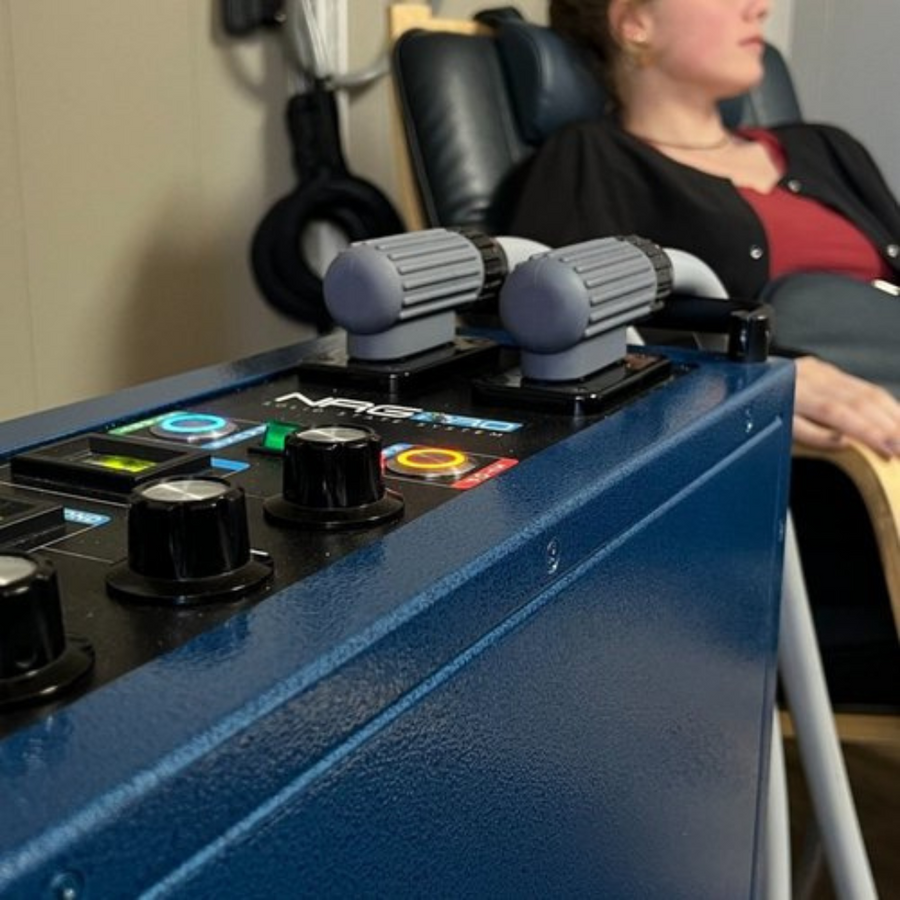 Patient seated next to a PEMF therapy machine